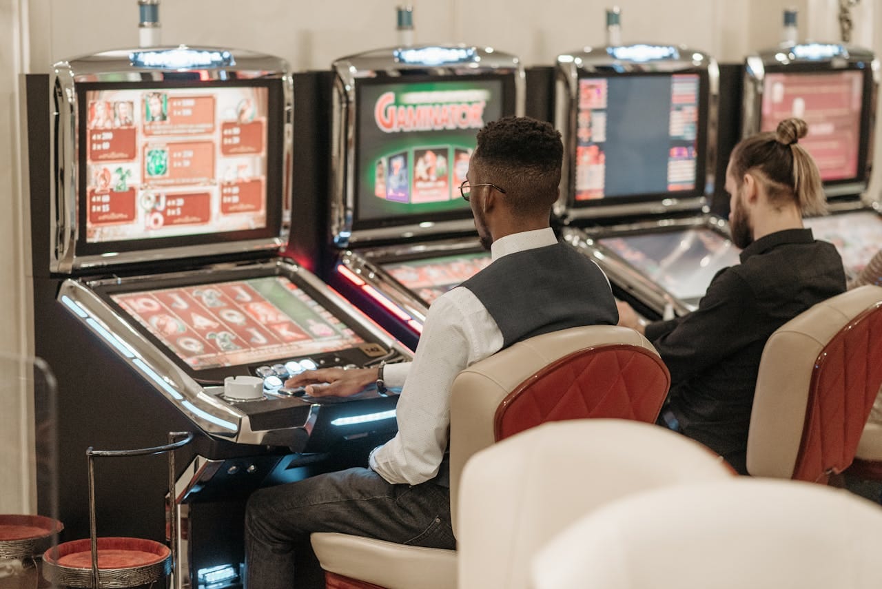 The Rise of Pragmatic Play’s Top Slots 1 A group of men playing slot machinesAI-generated content may be incorrect.